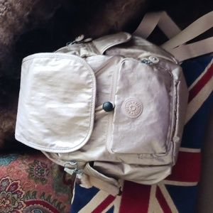 Metallic pink Kipling backpack. Lots of pockets, drawstrings, zips new photos
